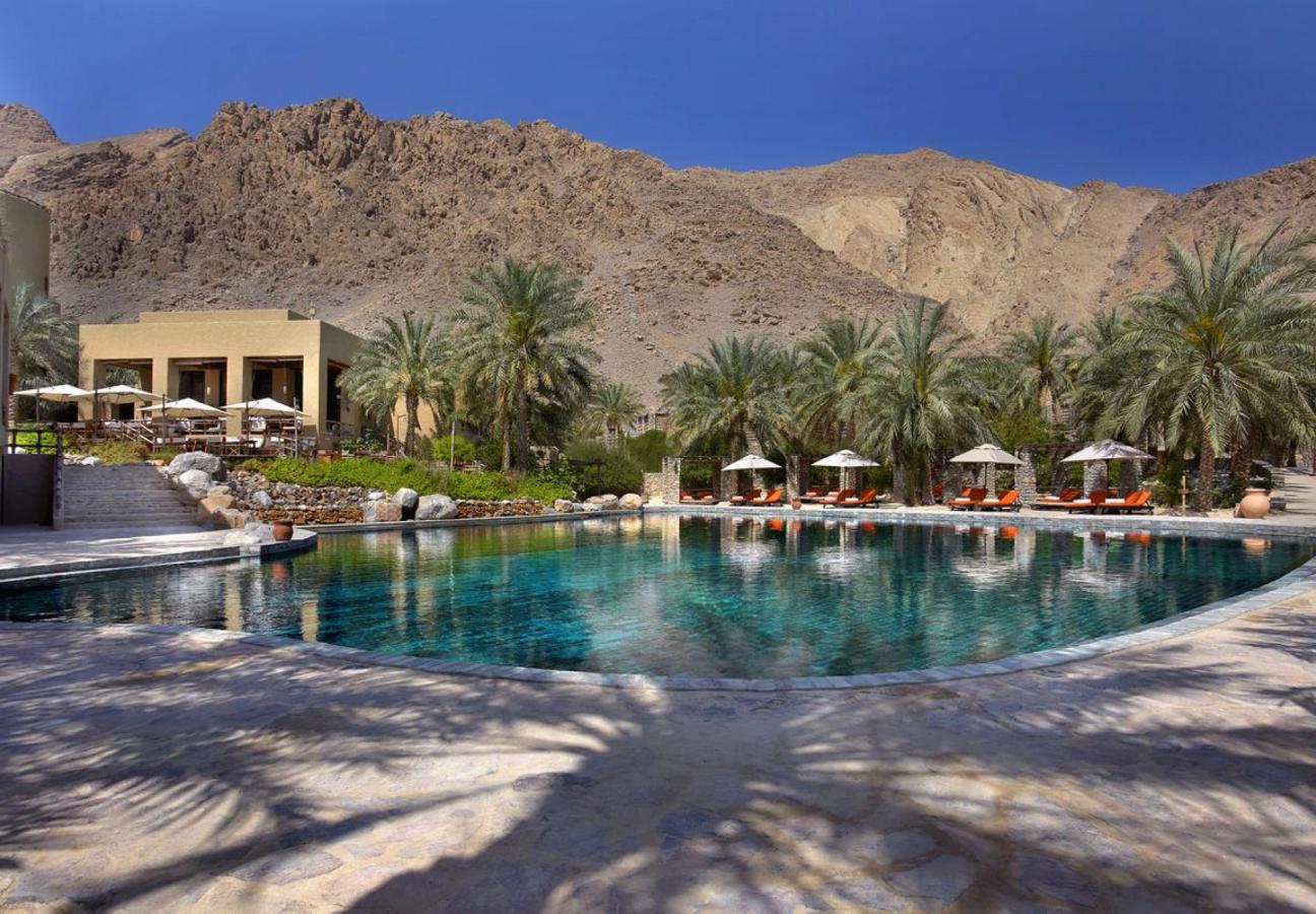 Pool beneath the mountains at Six Senses Zighy Bay