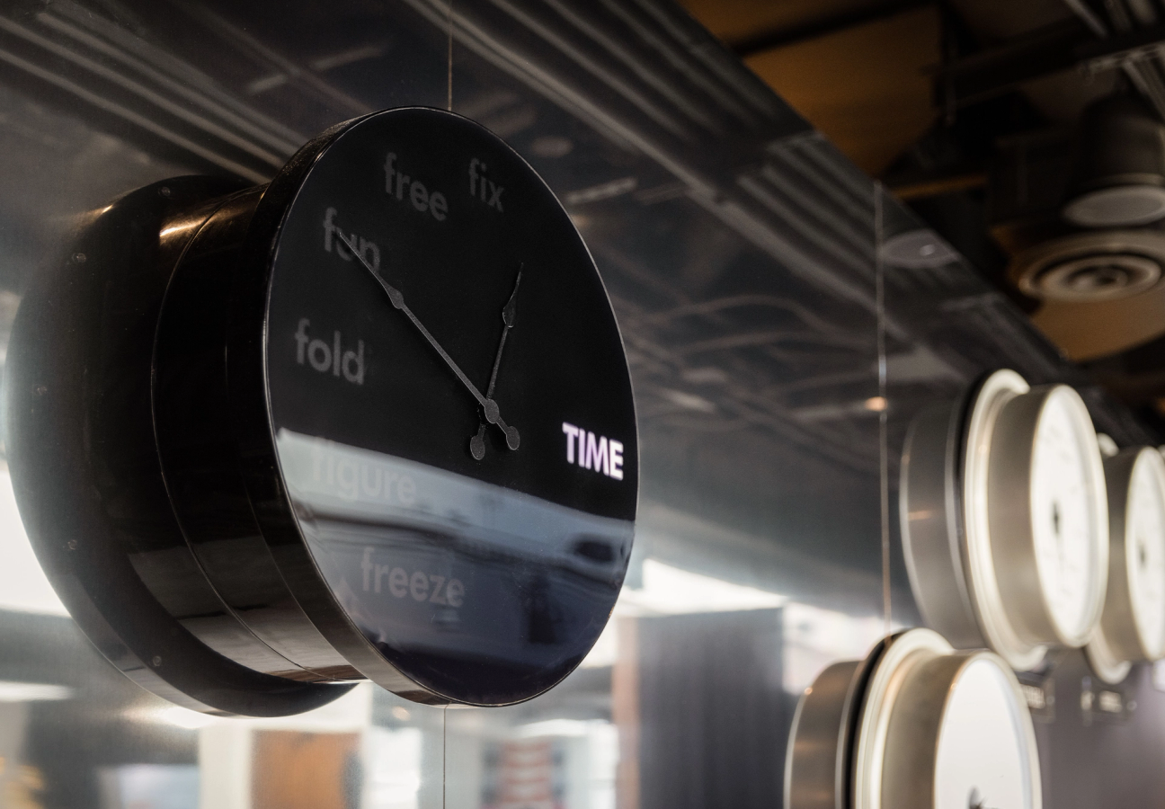 A picture of a black clock in an art installation