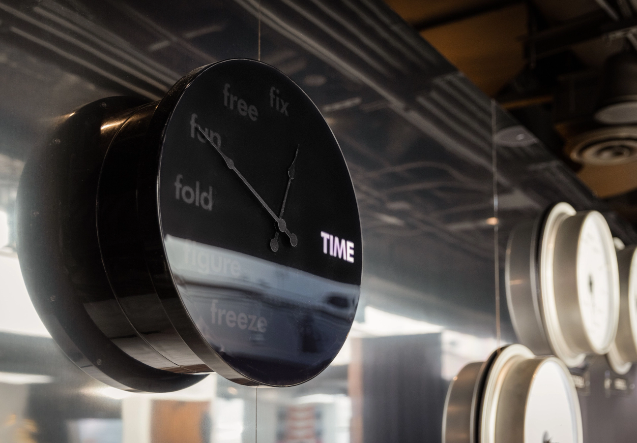 A picture of a black clock in an art installation