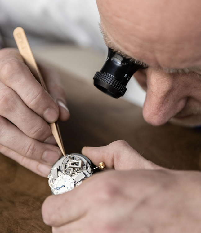 A man inspecting the inside of a watch