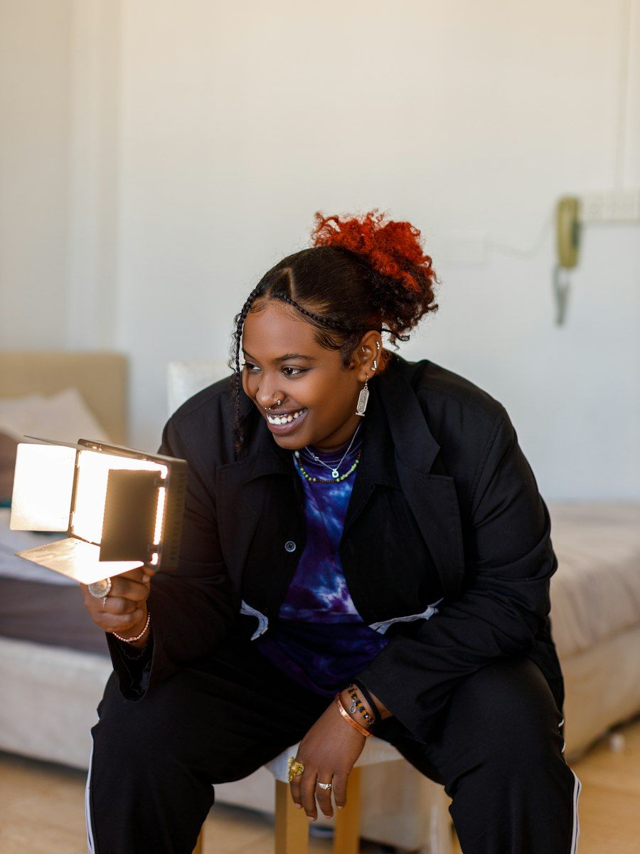 Content creator and social media manager filming with a small video light