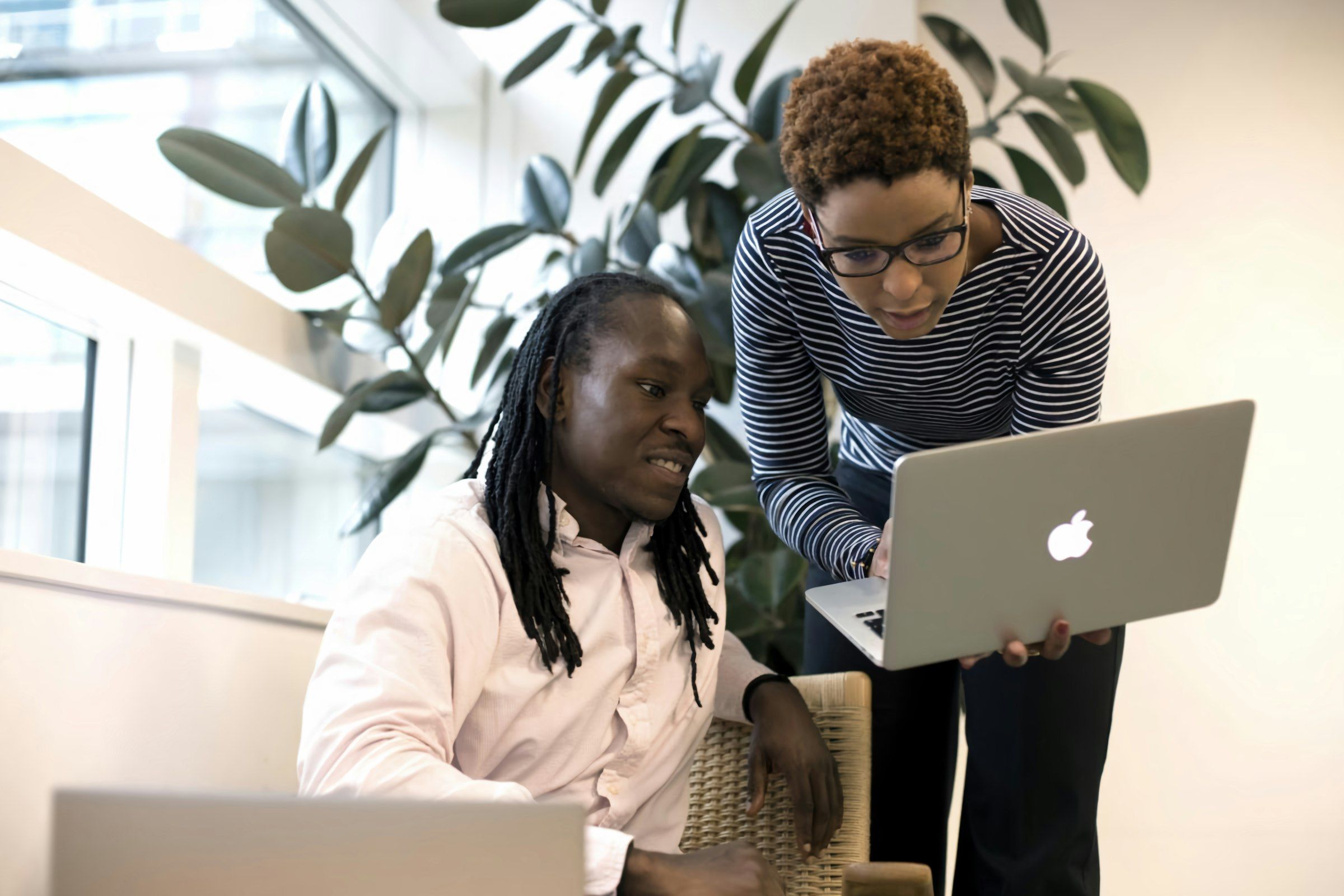In-house marketing team reviewing a social media campaign on a laptop in an office