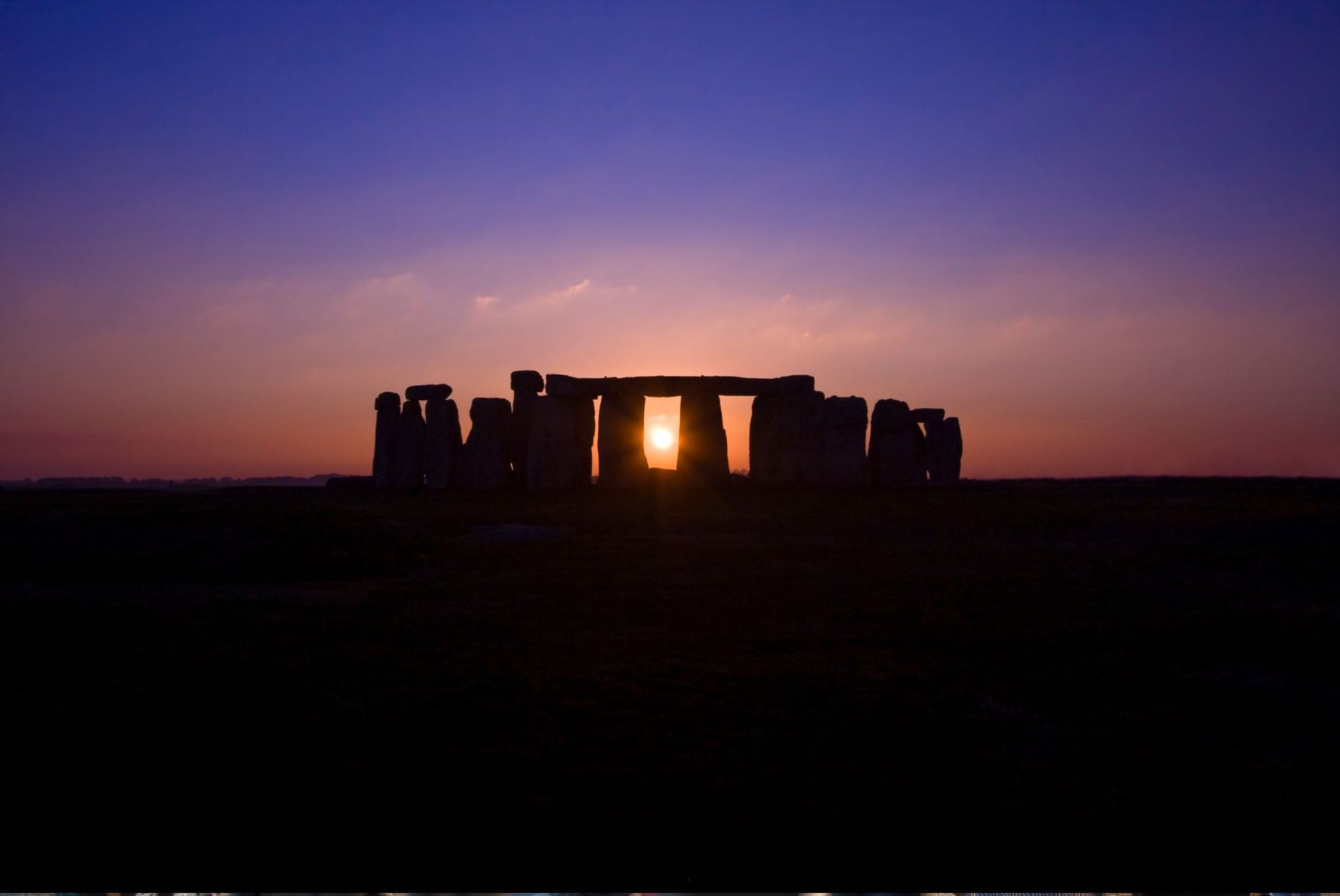 Why do people visit Stonehenge on the Summer Solstice day?