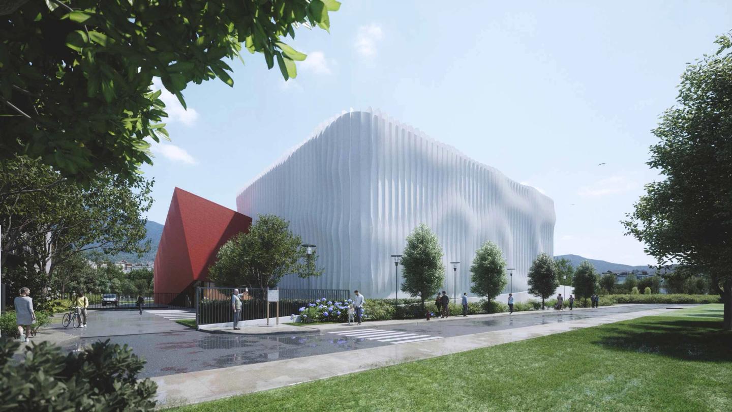 Perspective du studio de cinéma d'Aubervilliers depuis la rue, façade ondulée blanche et volume rouge