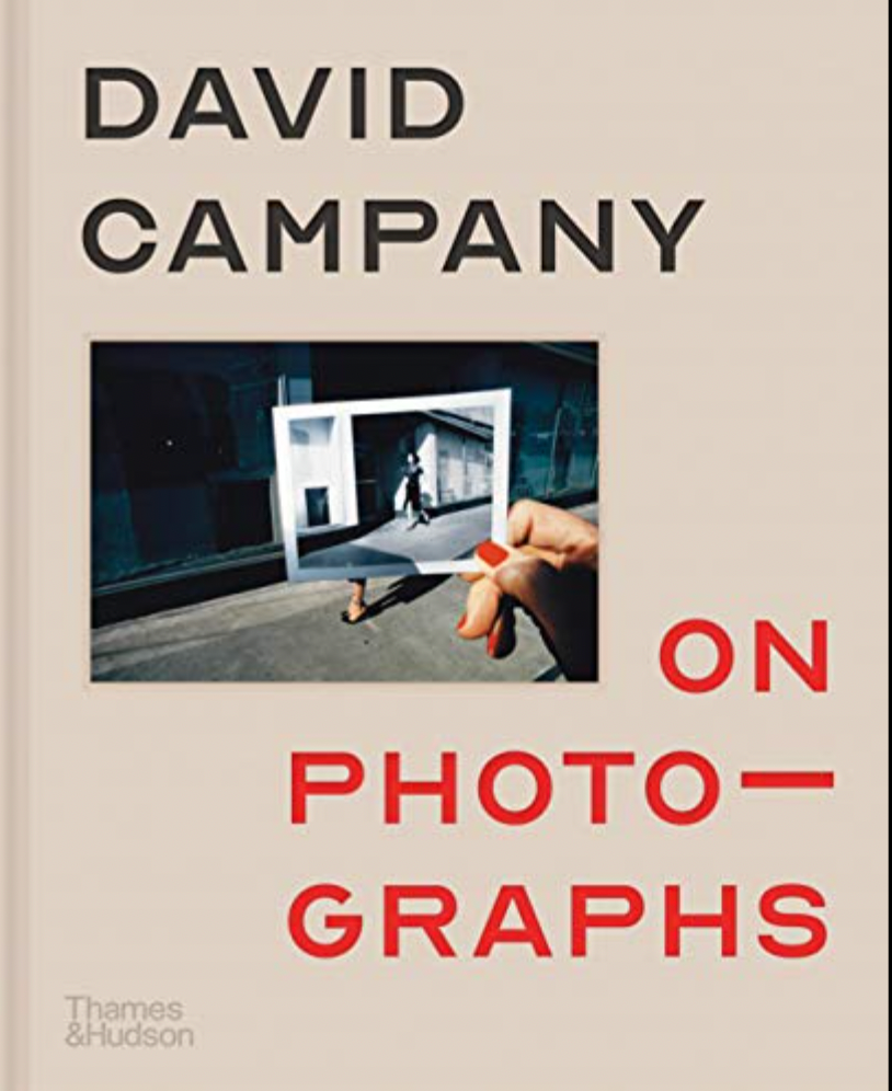 Image of a small photograph, of a hand holding a black and white photograph, on a beige background with large text reading ‘David Campany on Photographs’.