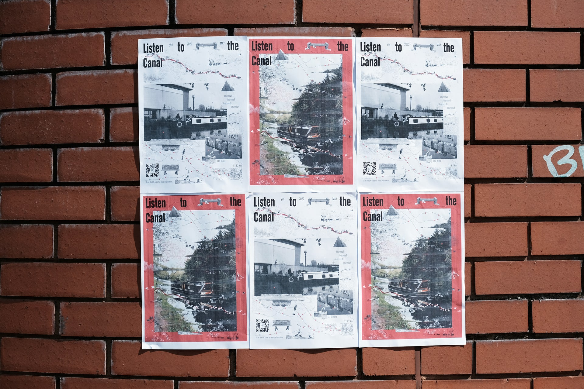 Image of six paper posters, in two alternating designs, featuring black and white photographs of canal boats and text reading ‘Listen to the Canal’, placed in a grid on a brown brick wall.