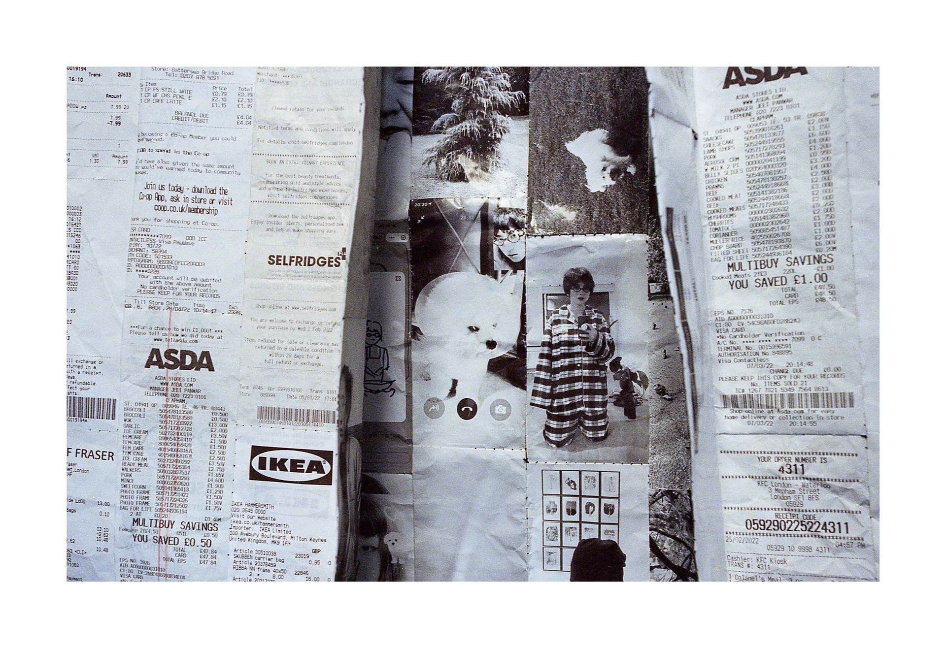 Aerial view of a collage of black and white photographic images lining what appears to be a slightly wonky rectangular open box, placed on a surface covered in a collage of shopping receipts. 
