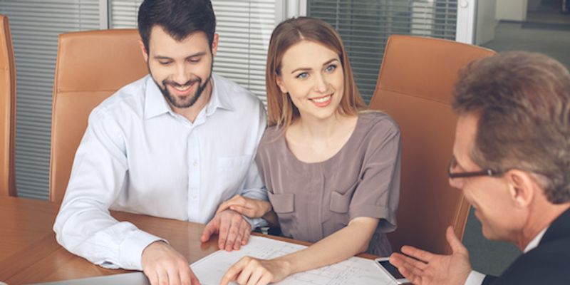 Couple talking to VA loan specialist.