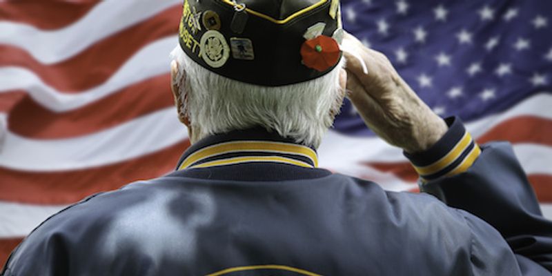 Veteran saluting to American flag.