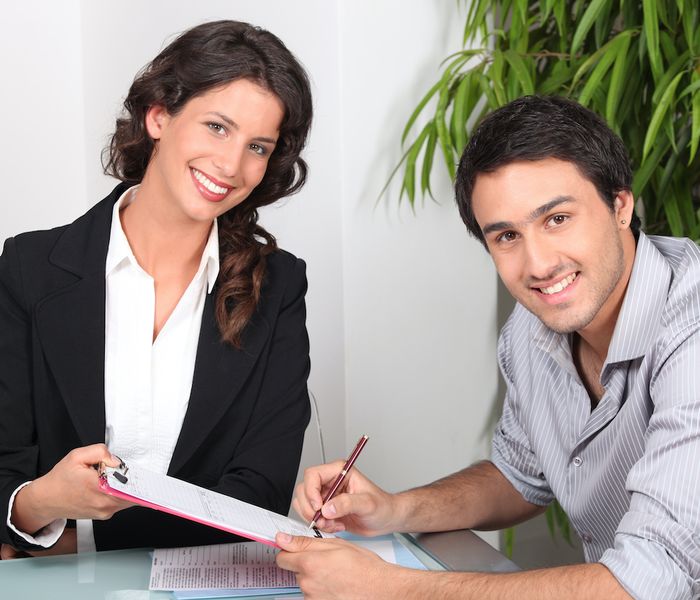 Real estate agent with a client discussing about title insurance.