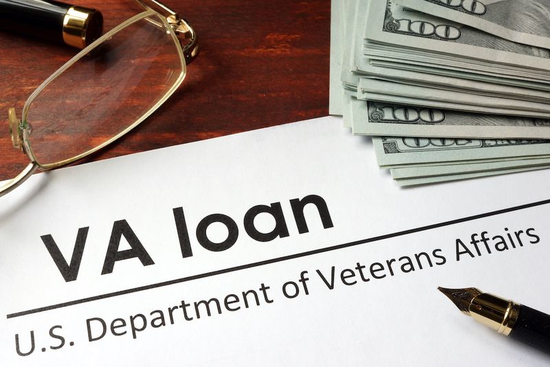 VA loan document with pen and money on the table.
