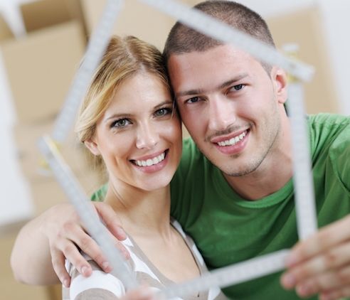 Couple holding house illustration.