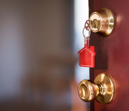 Opening door with a house key.