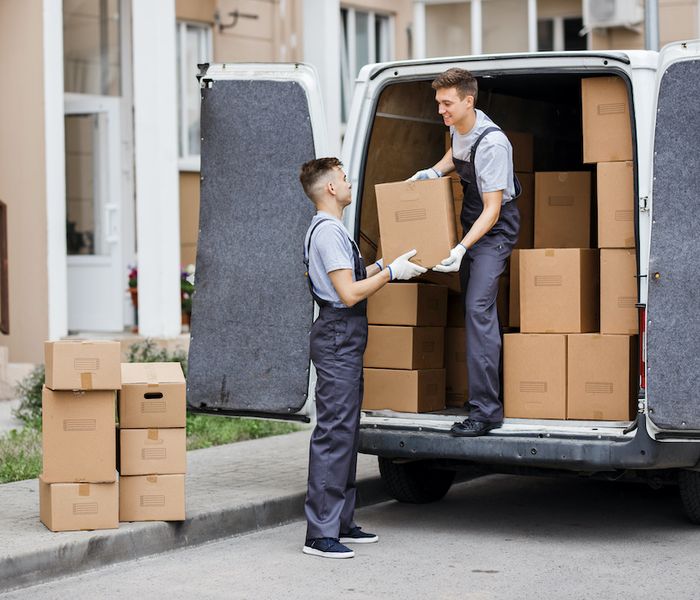 Movers piling boxes - tips for smoothly moving to a new house.