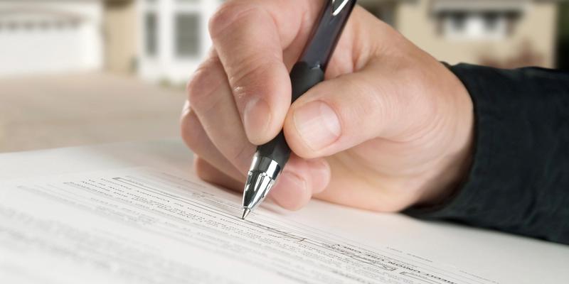 Signing title insurance document.
