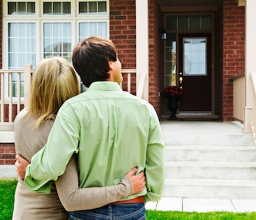 Couple looking at their newly bought house.