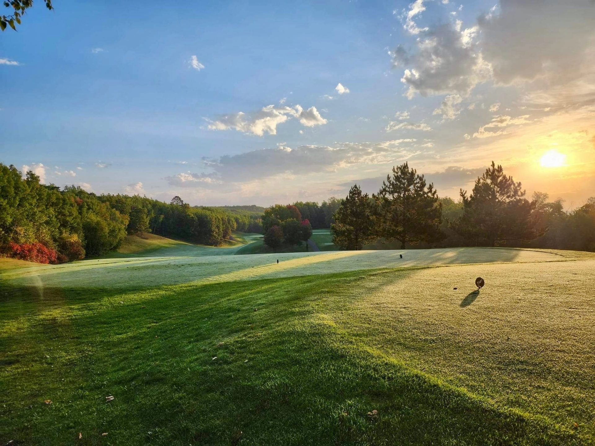 Aerial view of the Golden Eagle clubhouse and surrounding Northwoods fairways at golden hour