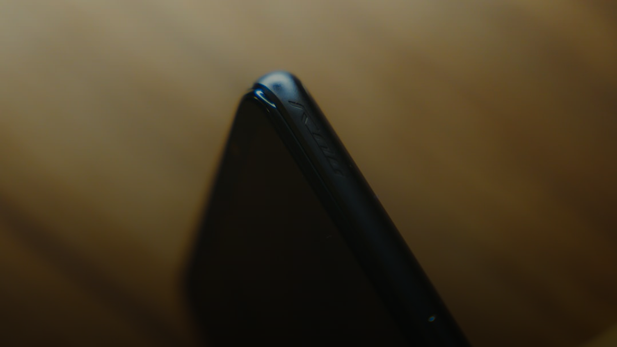 black smartphone on brown wooden table