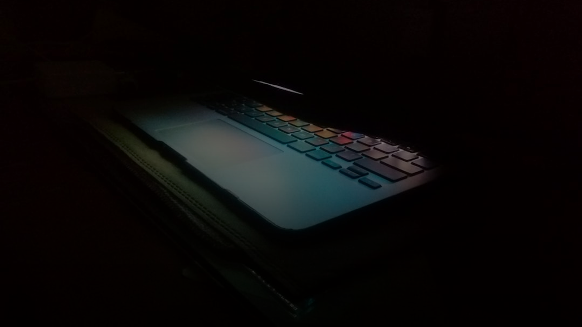 a laptop computer lit up in the dark