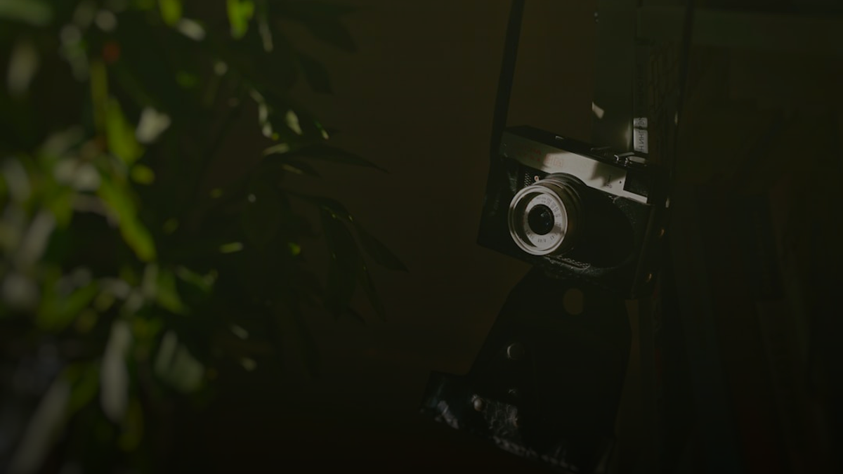 black and silver camera on black surface