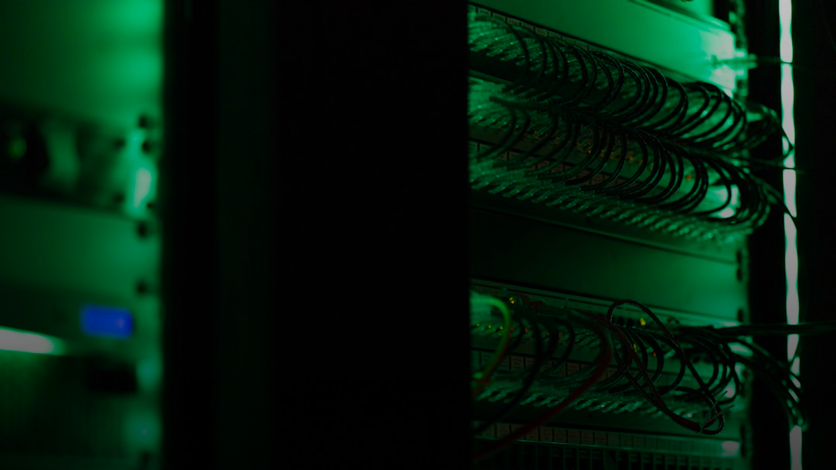 a rack of electronic equipment in a dark room