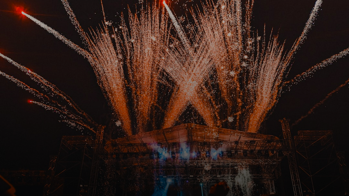 a crowd of people watching fireworks on a stage