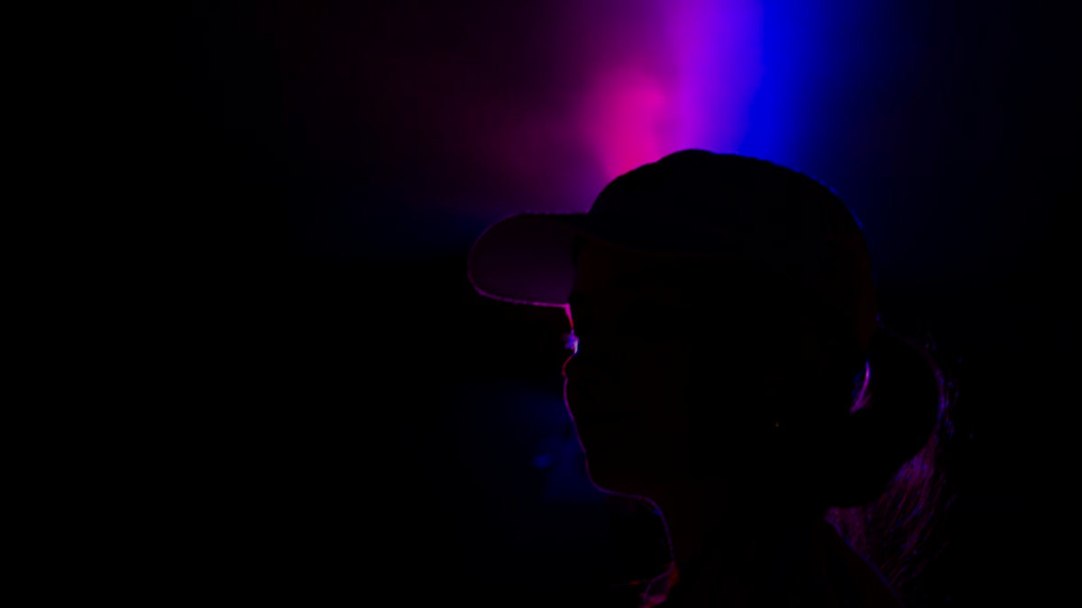 A silhouette is lit up with vibrant colors.