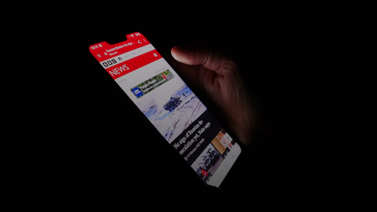 a person holding a cell phone in their hand