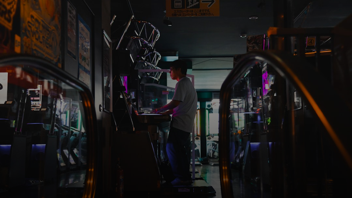 man playing on game arcade