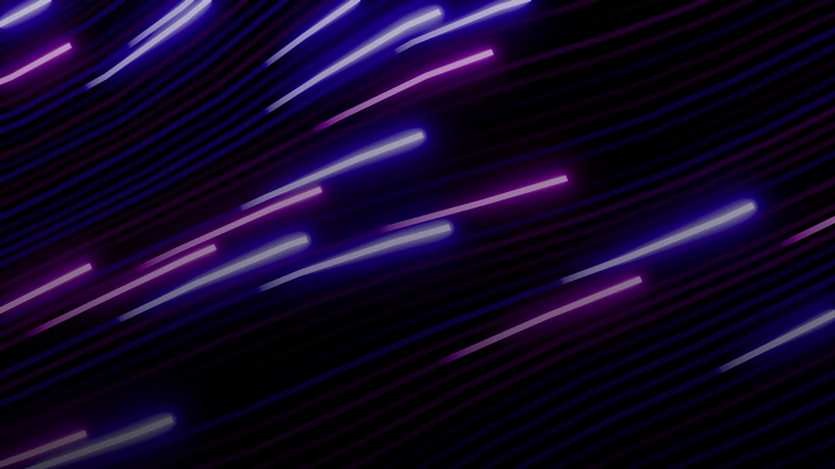 Abstract streaks of purple and pink lights on black background