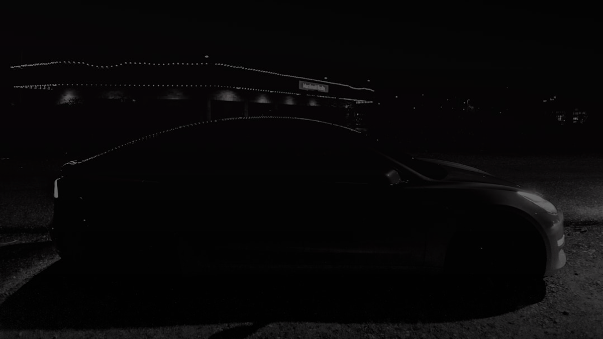 red car on black asphalt road during night time