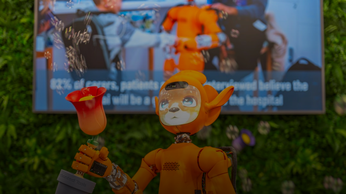 Orange robot holding a potted plant with a flower.