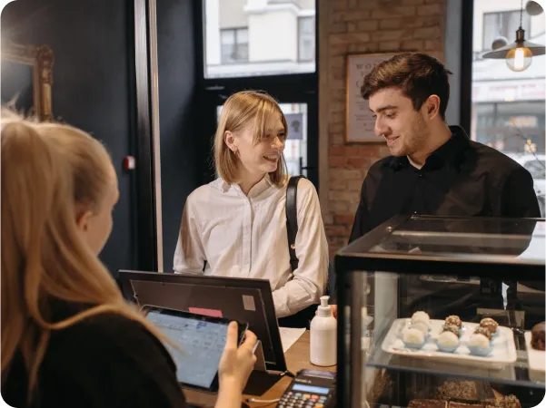 Seamless order sending from FineDine to POS Integrations with man and woman in front of computer.