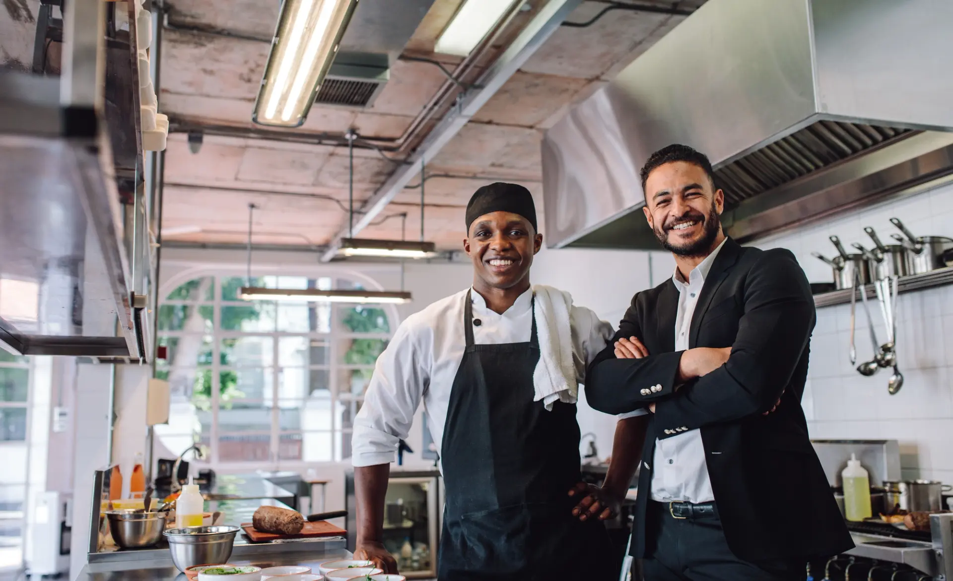 Two chefs in a commercial kitchen, working together with dedication and passion.
