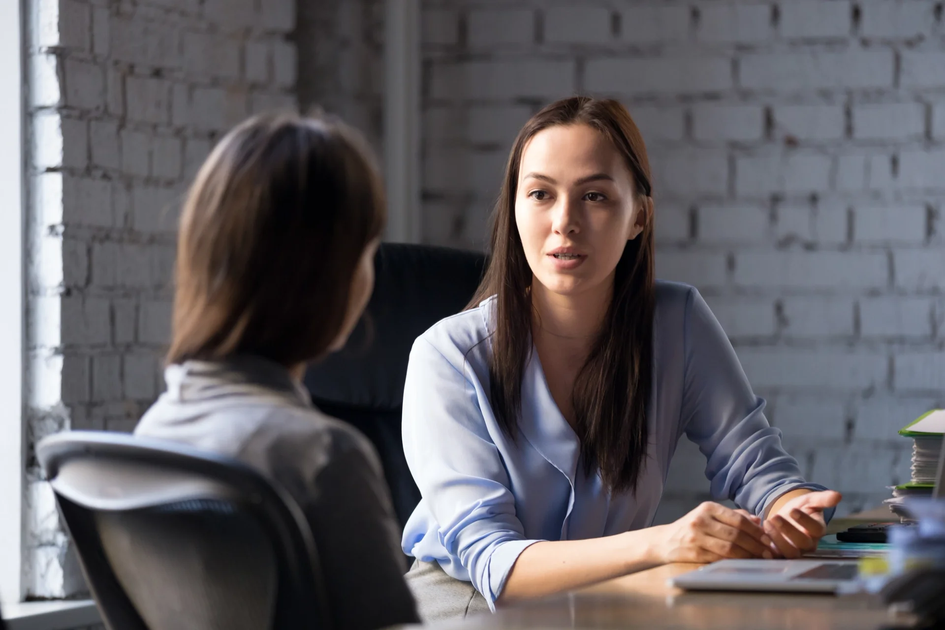 A conversation between two women in an office, possibly related to human resources matters.