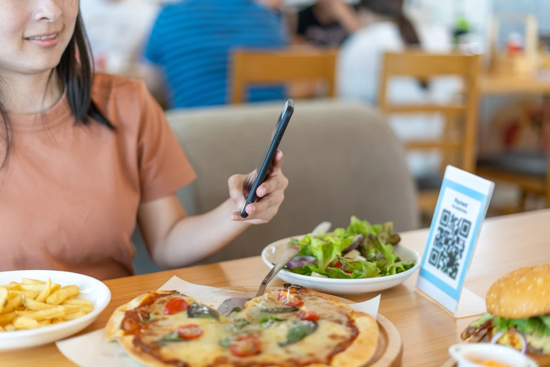 A woman browsing a digital menu.