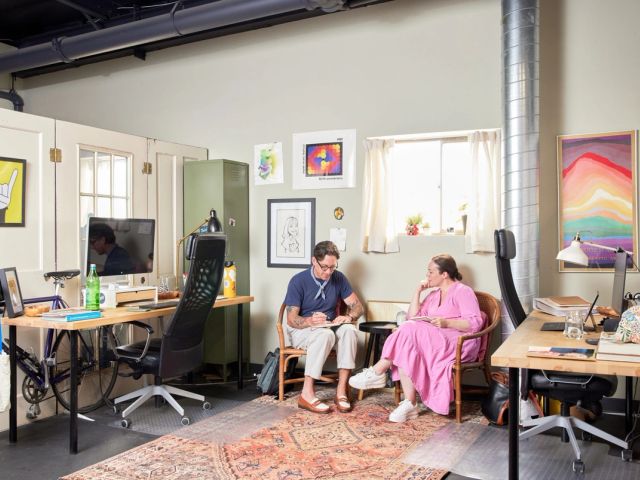 Personalized dedicated desk with rainbow flag and stickers at The Studio Boulder, Boulder, CO