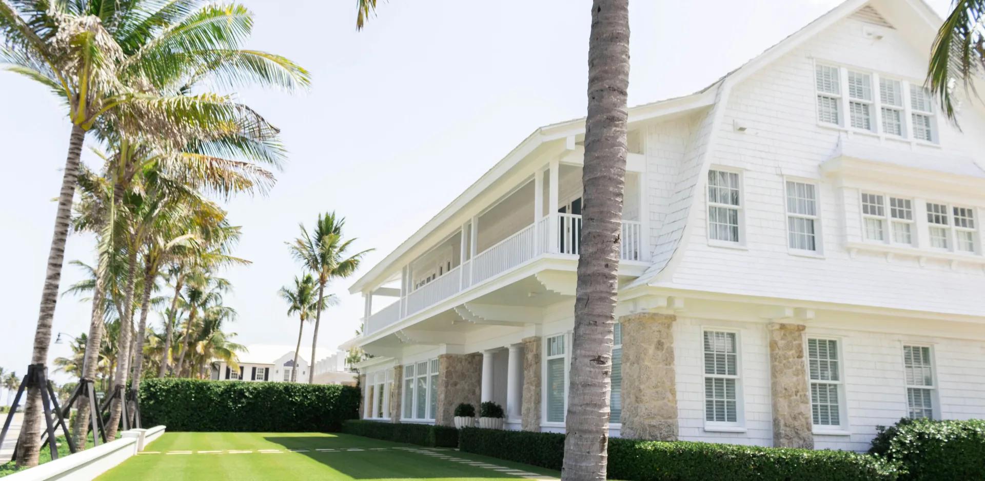 large house with palm trees around the yard