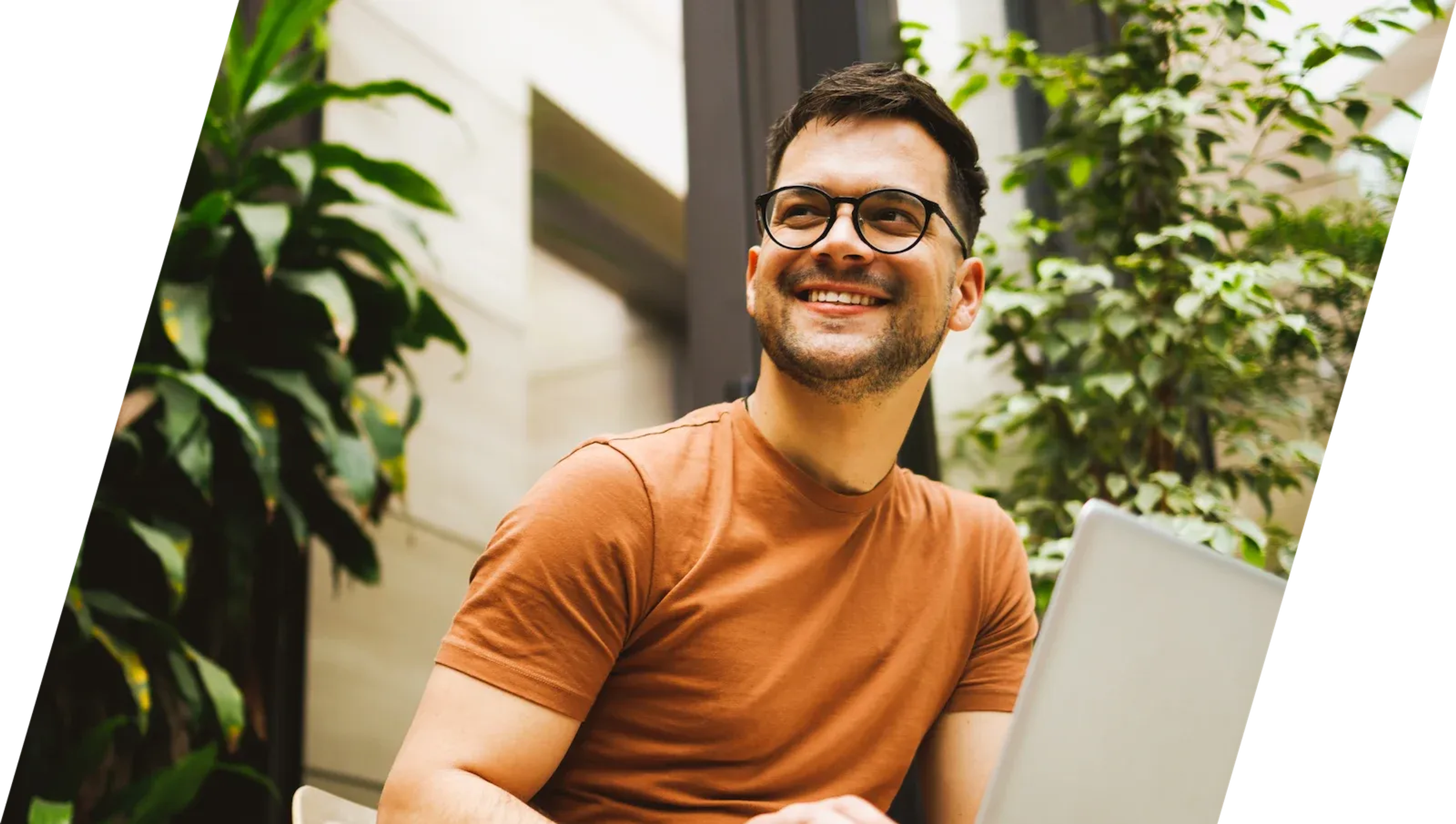 Man looks happy while working on his laptop.
