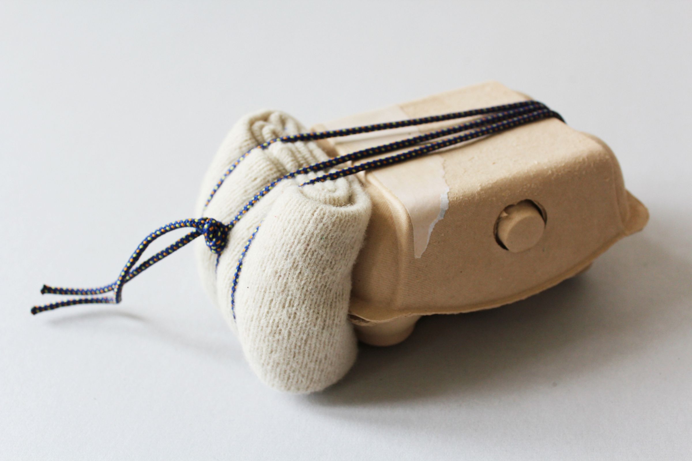 Deborah Ligorio, Survival Kit - Bellissima 1/99, 2012, assemblage: egg box, paper, woollen cloth, string, 19x12x9 cm.