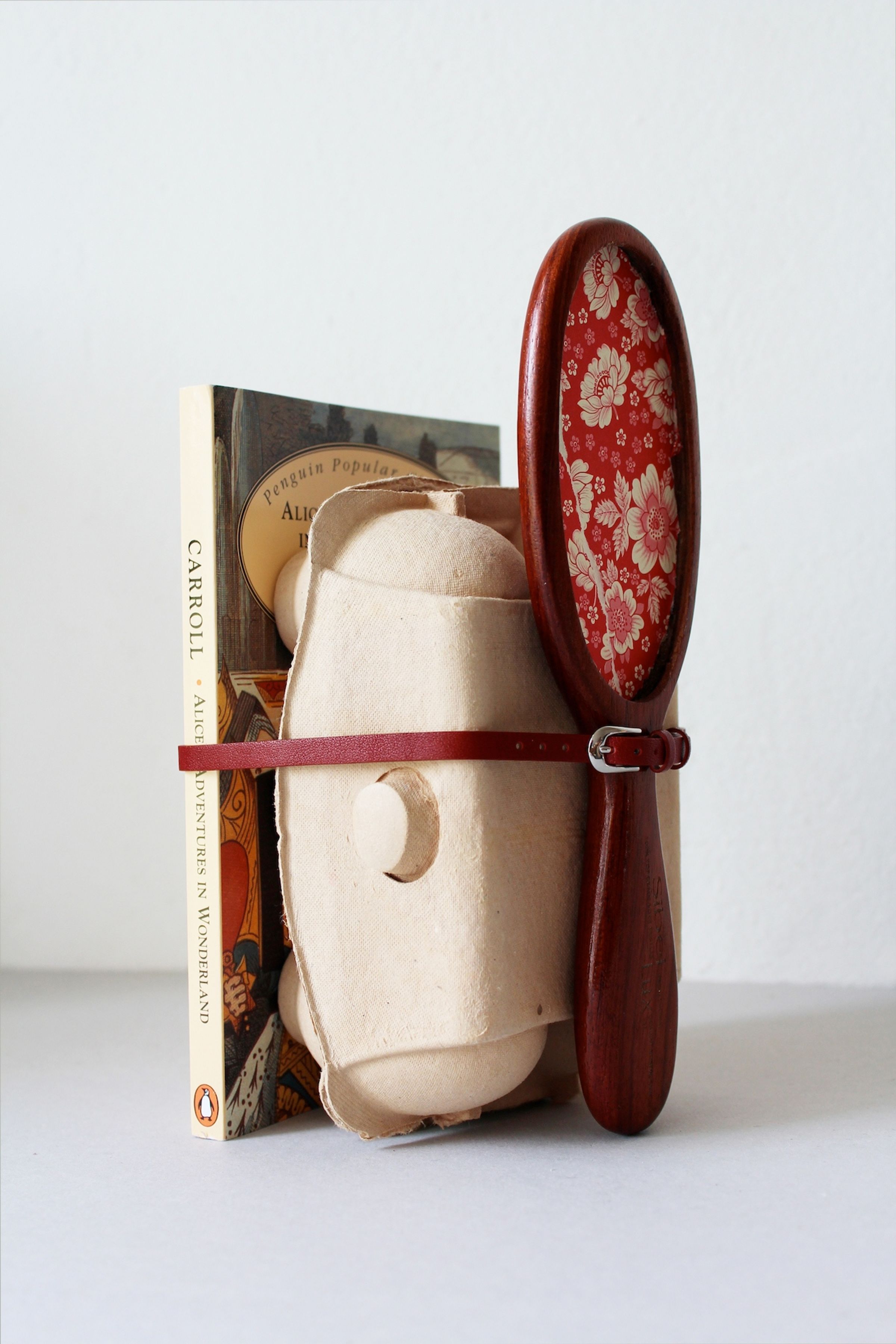 Deborah Ligorio, Survival Kit - The person who kept functioning 2/99, 2012, assemblage: book, egg box, wooden brush handle, paper, belt, 22 x 14 x 12 cm.