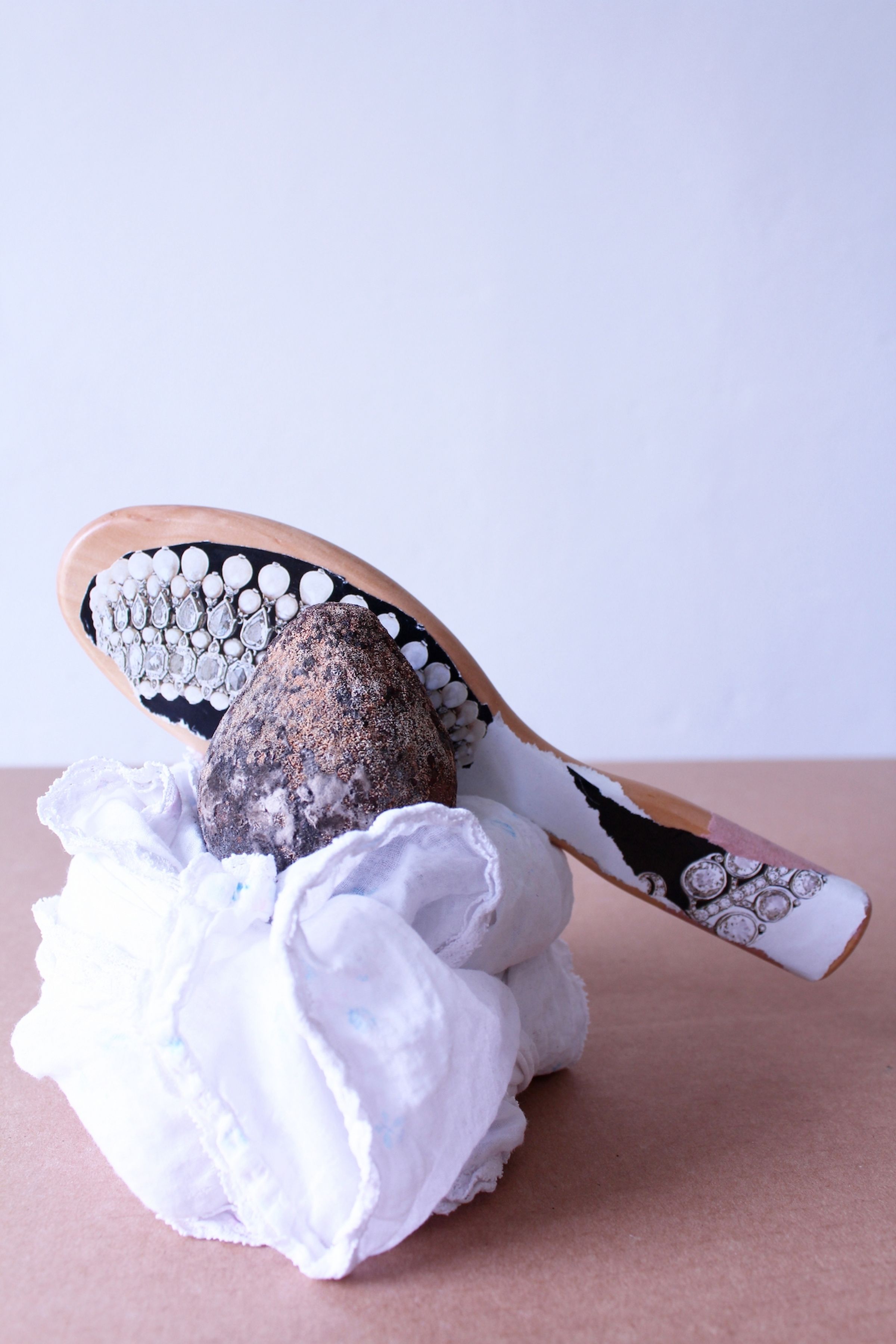 Deborah Ligorio, Survival Kit – Gayatri Spivak 1/99, 2013, assemblage: cloth, avocado seed, brush handle, 22x19x11cm.