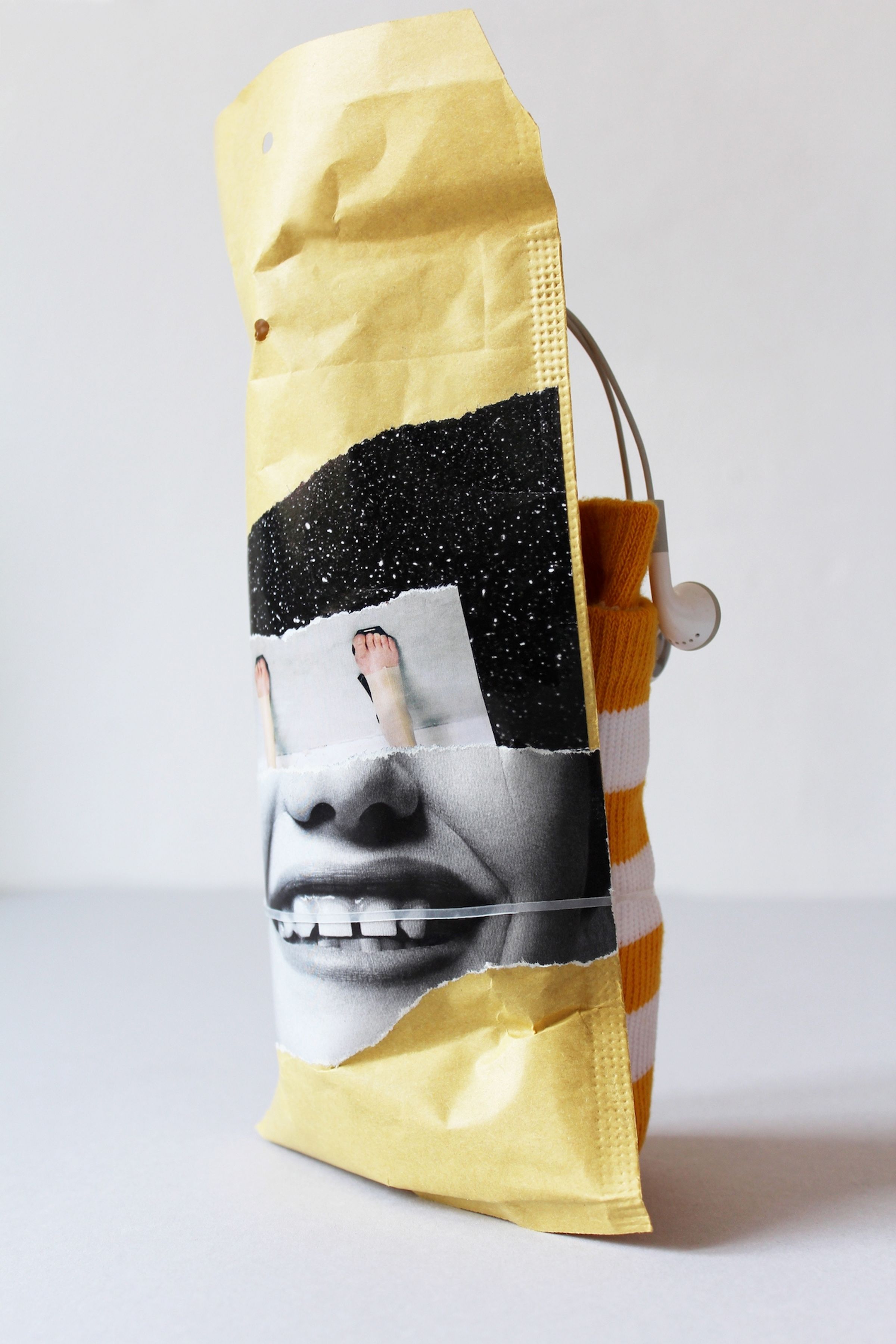 Deborah Ligorio, Survival Kit – Researcher Marcella 1/99, 2012, assemblage: kraft bubble envelope, in-ear headphones, socks, rubber band, 27x13x12 cm.