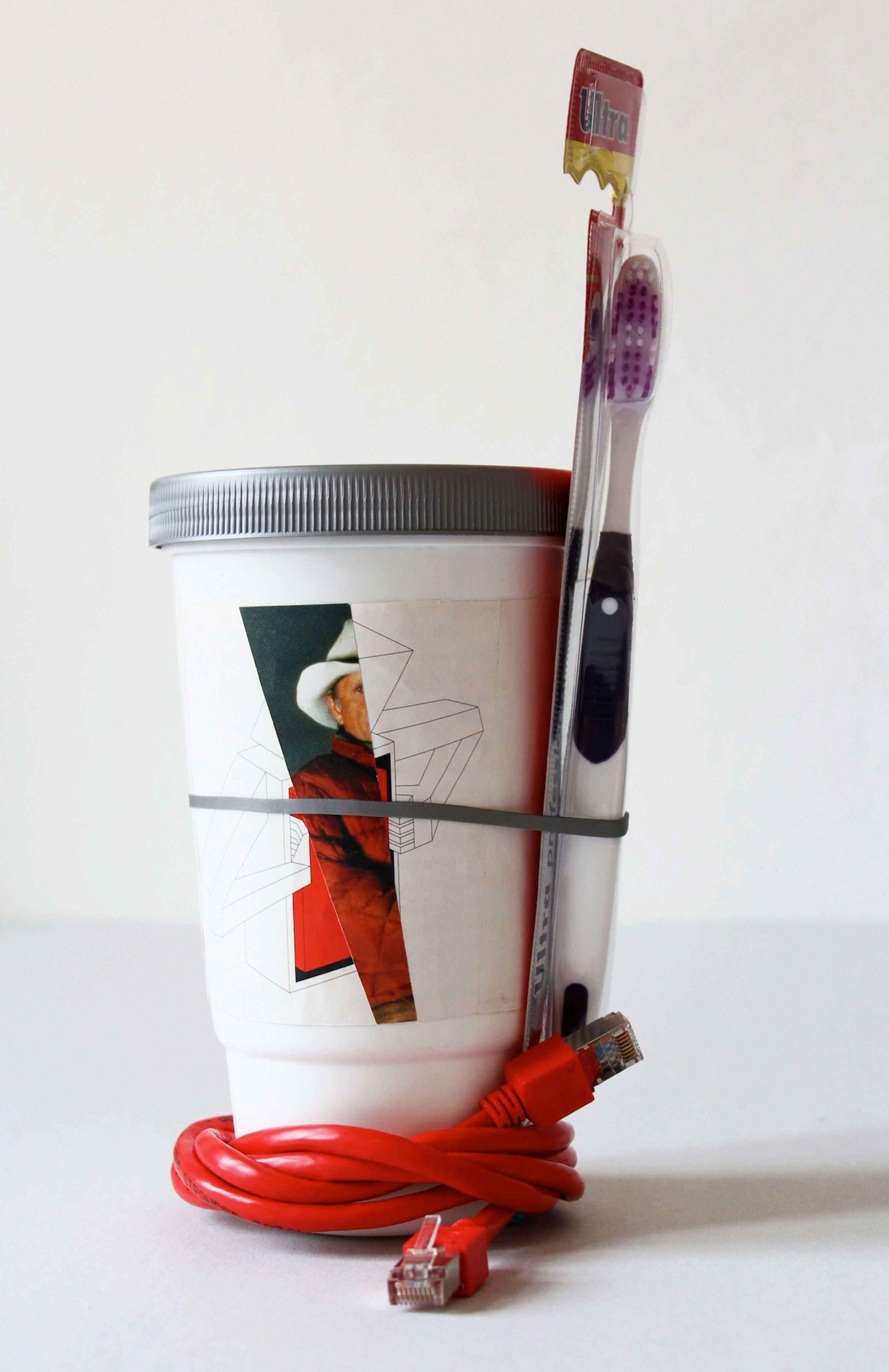 Deborah Ligorio, Survival Kit - Kostas 1/99, 2012, assemblage: ethernet cable, toothbrush, plastic shaker cup, paper, rubber band, 29x13x12 cm