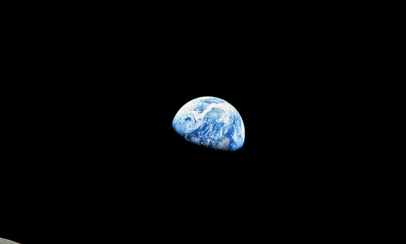 A photo of planet Earth from space. A blue marble in a sea of black