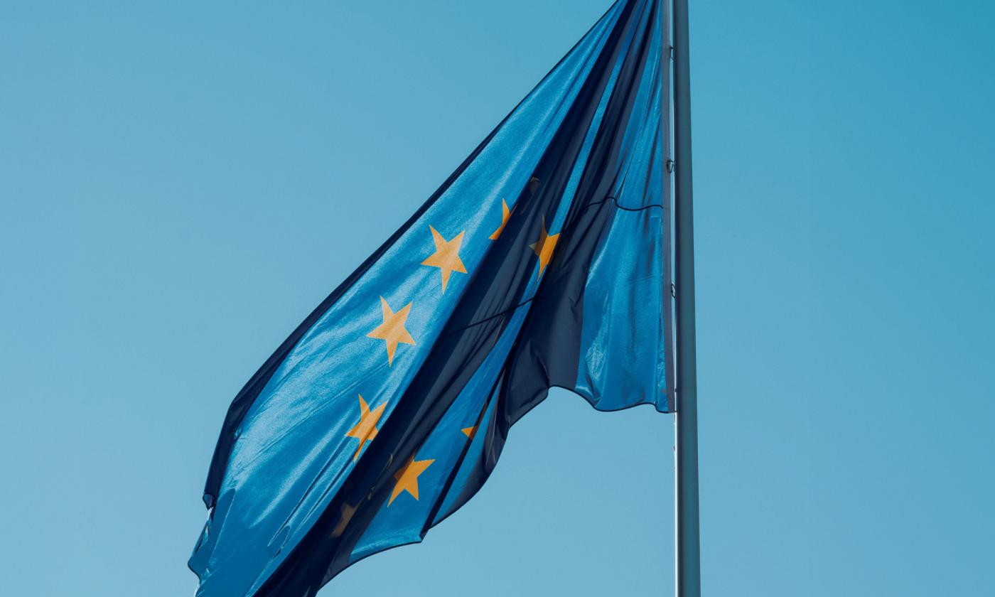 The primary image for this blog post from comundo about the EU's EPBD shows an EU flag against a blue sky.
