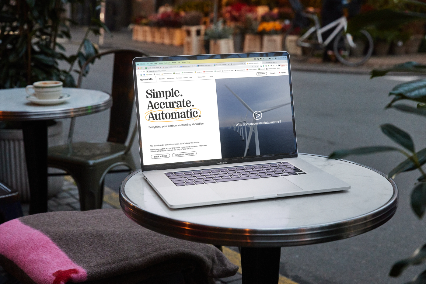 The new website shown on a laptop which is on a cafe table outoodrs