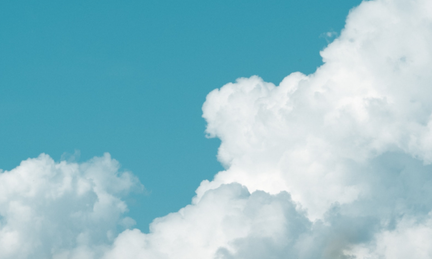 The main image for this comundo blog post about legacy vs. modern carbon accounting shows a blue sky framed by white fluffy clouds
