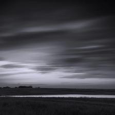 A long exposure photo of a field on the prairies taken in black and white