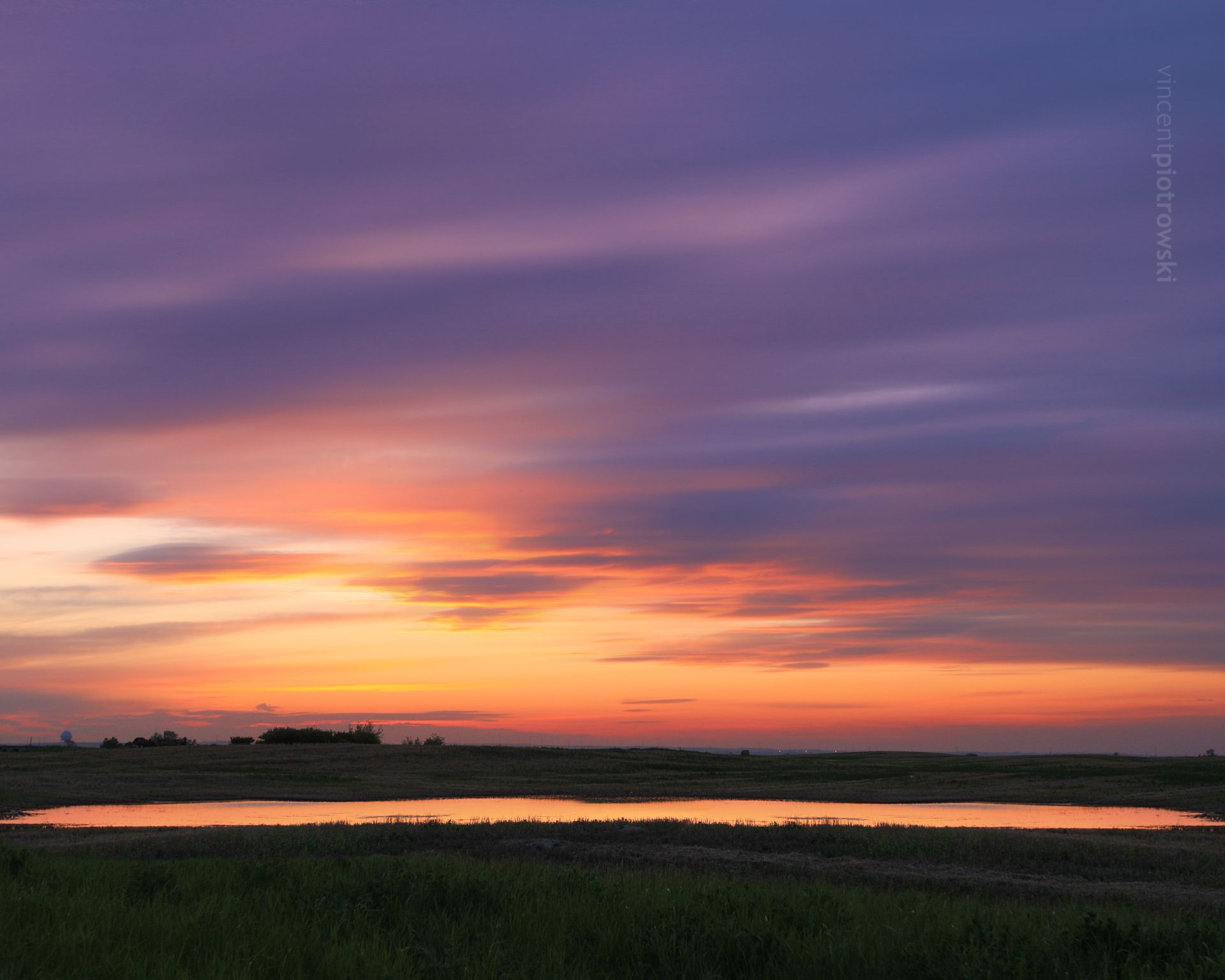 A long exposure photo of a field on the prairies taken in black and white